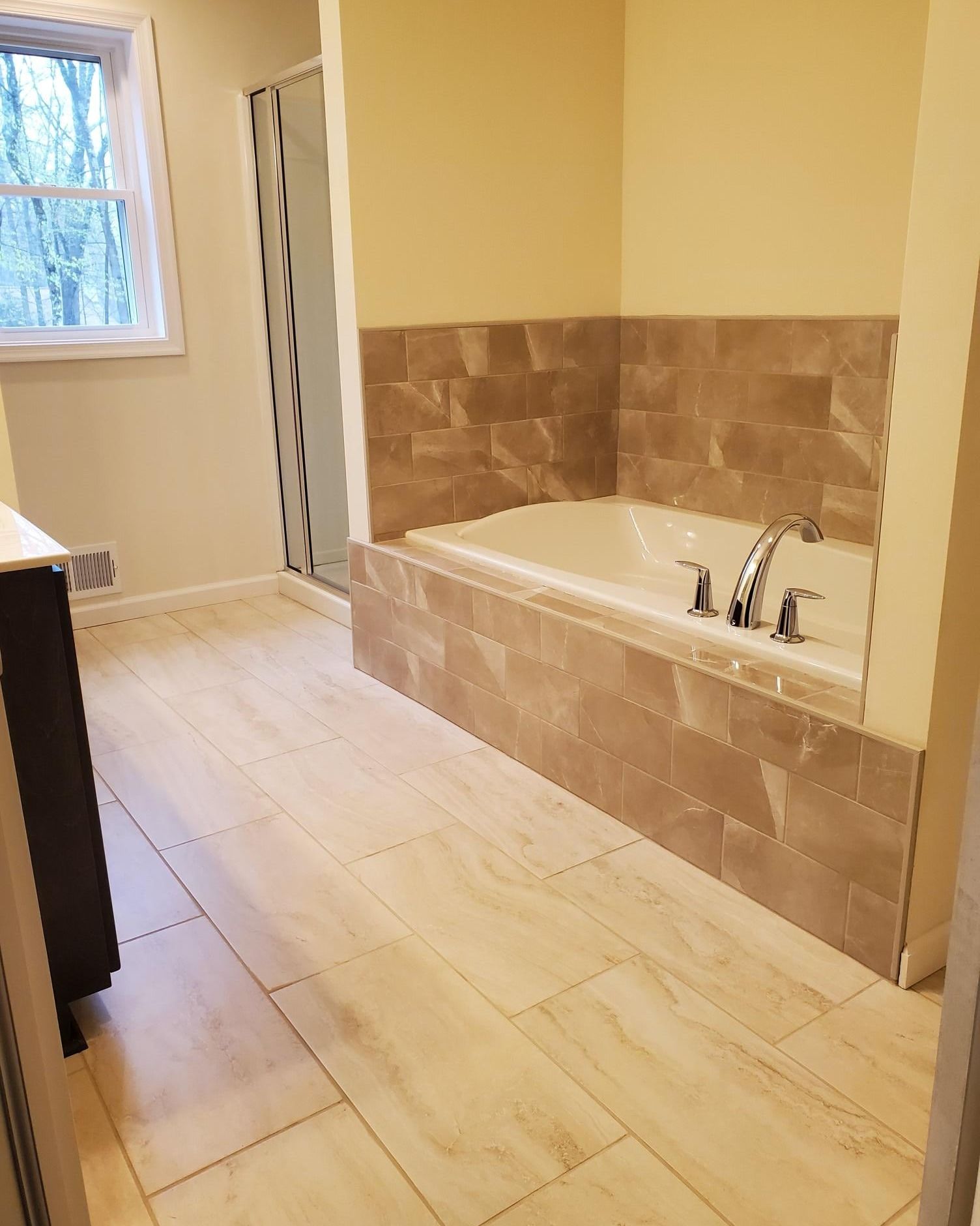 A bathroom with a tub and a shower.