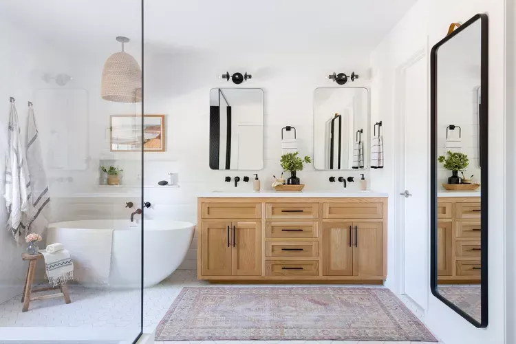 A bathroom with two sinks , a bathtub , and a large mirror. A bathroom with two sinks , a bathtub , and a large mirror.