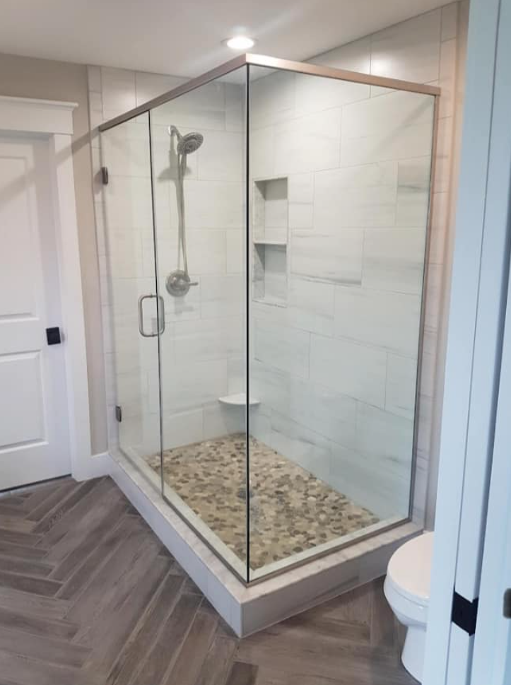 A bathroom with a walk in shower and a toilet.