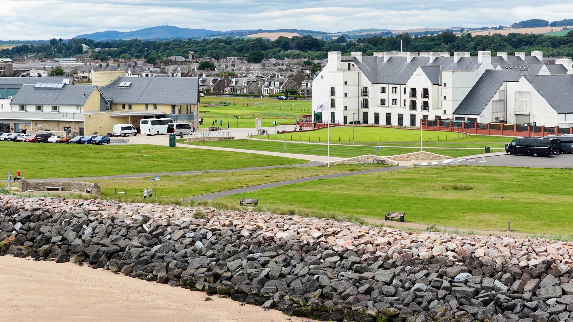 Aerial view of a clubhouse, next to a rocky coastline
