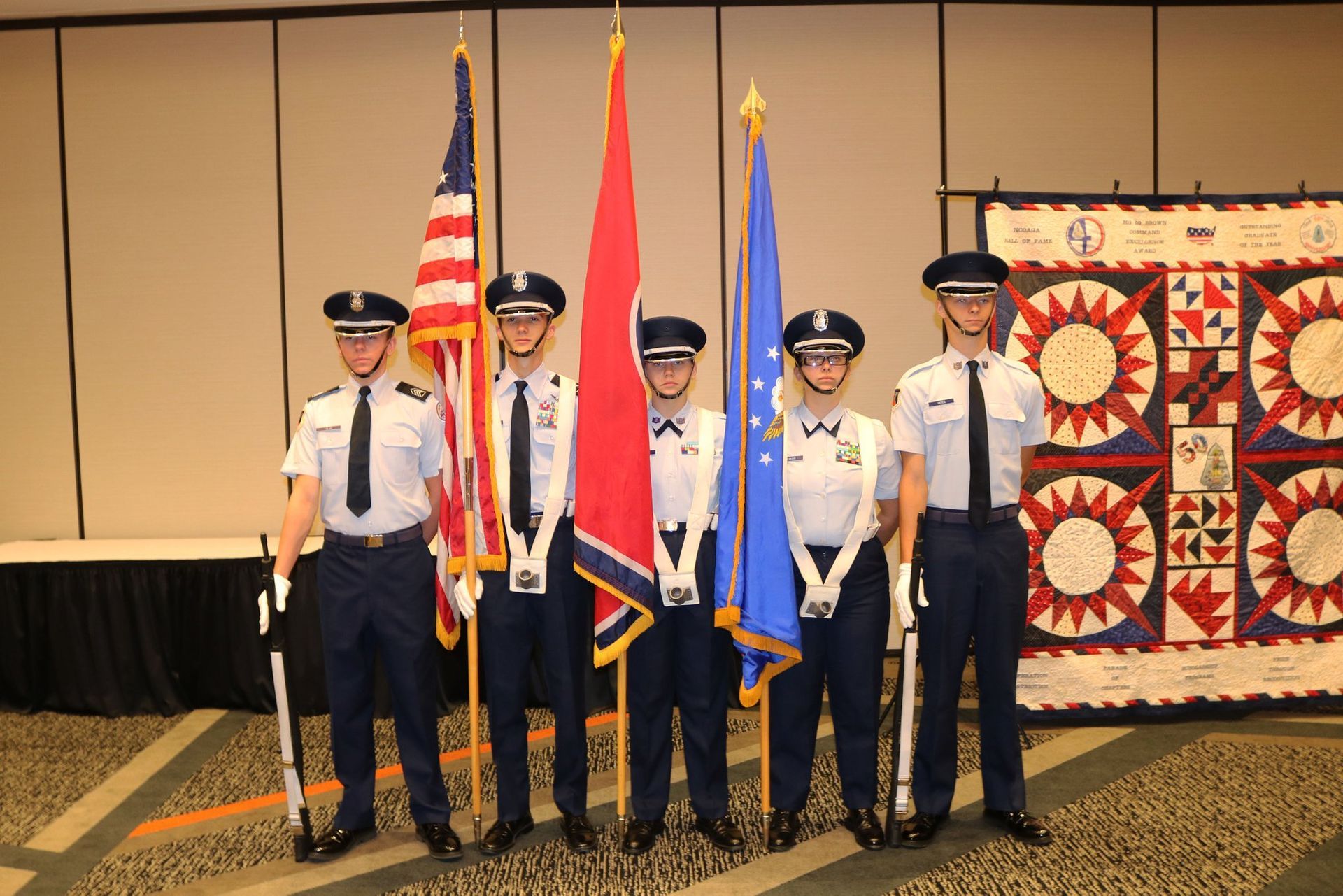 A group of soldiers standing next to each other holding flags.