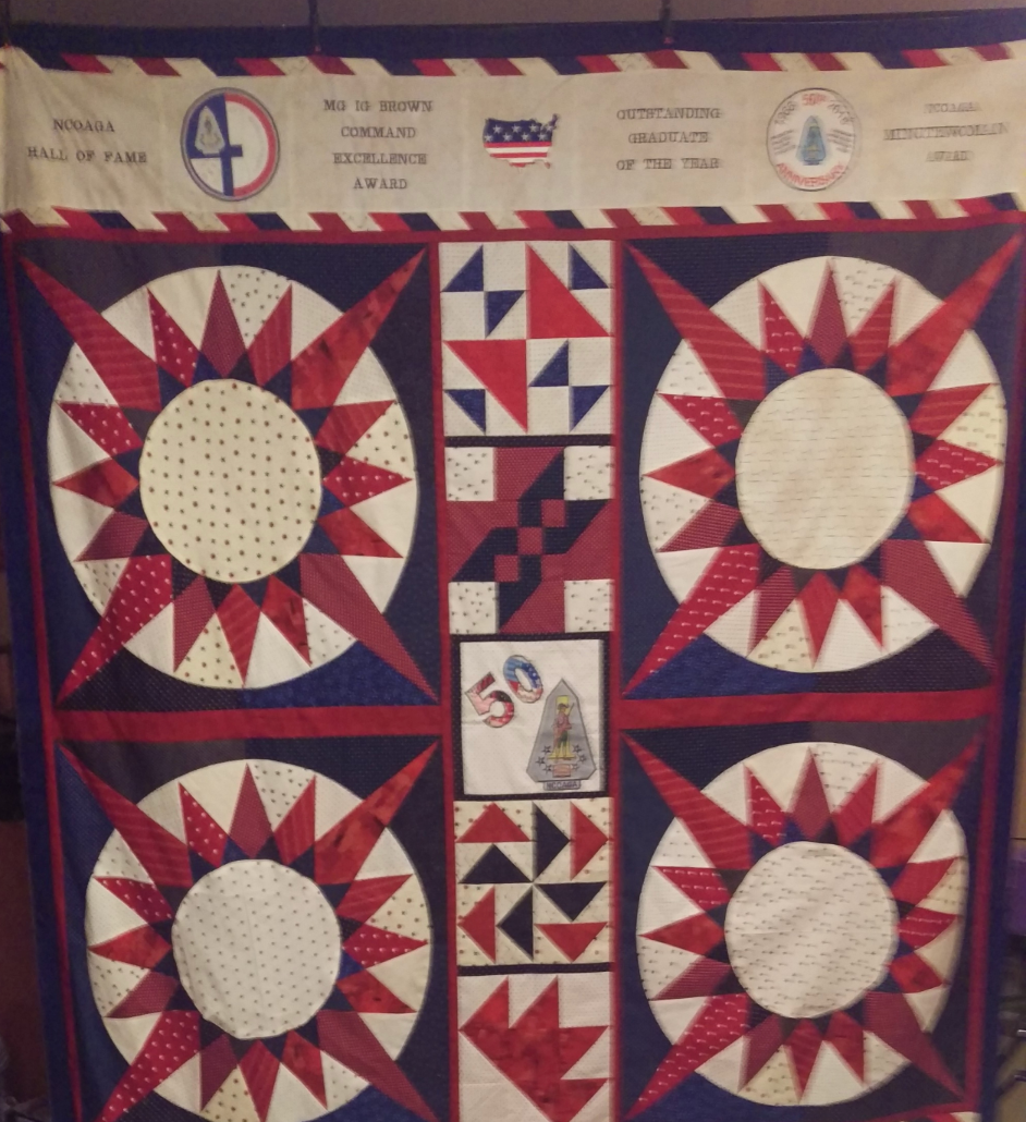 A red white and blue quilt with the number 4 on it