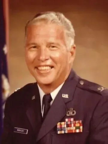 A man in a us air force uniform is smiling