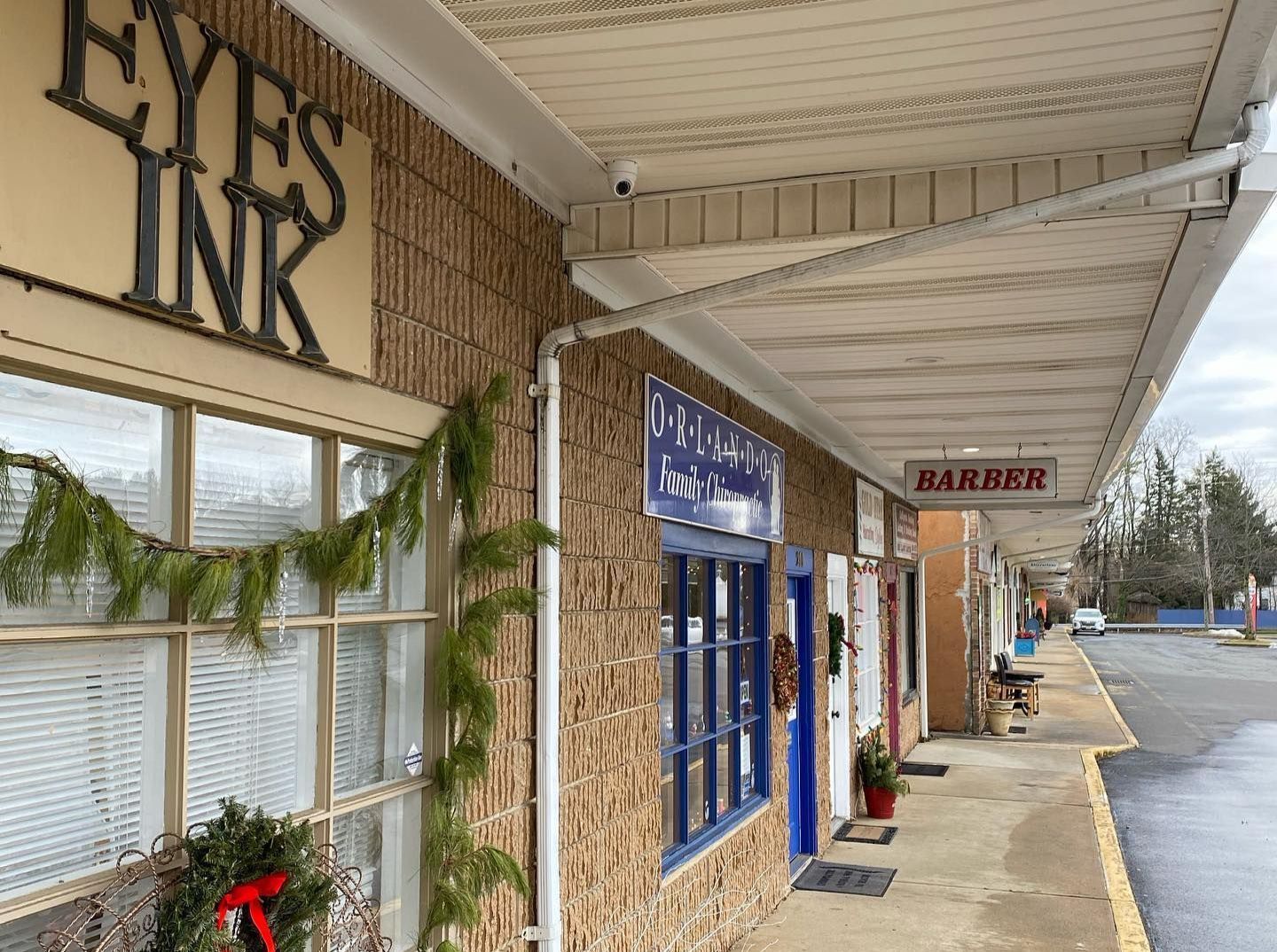 A building with a sign that says eyes ink on it