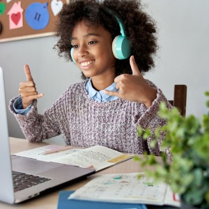 child wearing headphones on a zoom call