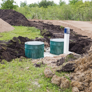 Partially buried utility tanks and pipe in a trench at a construction site