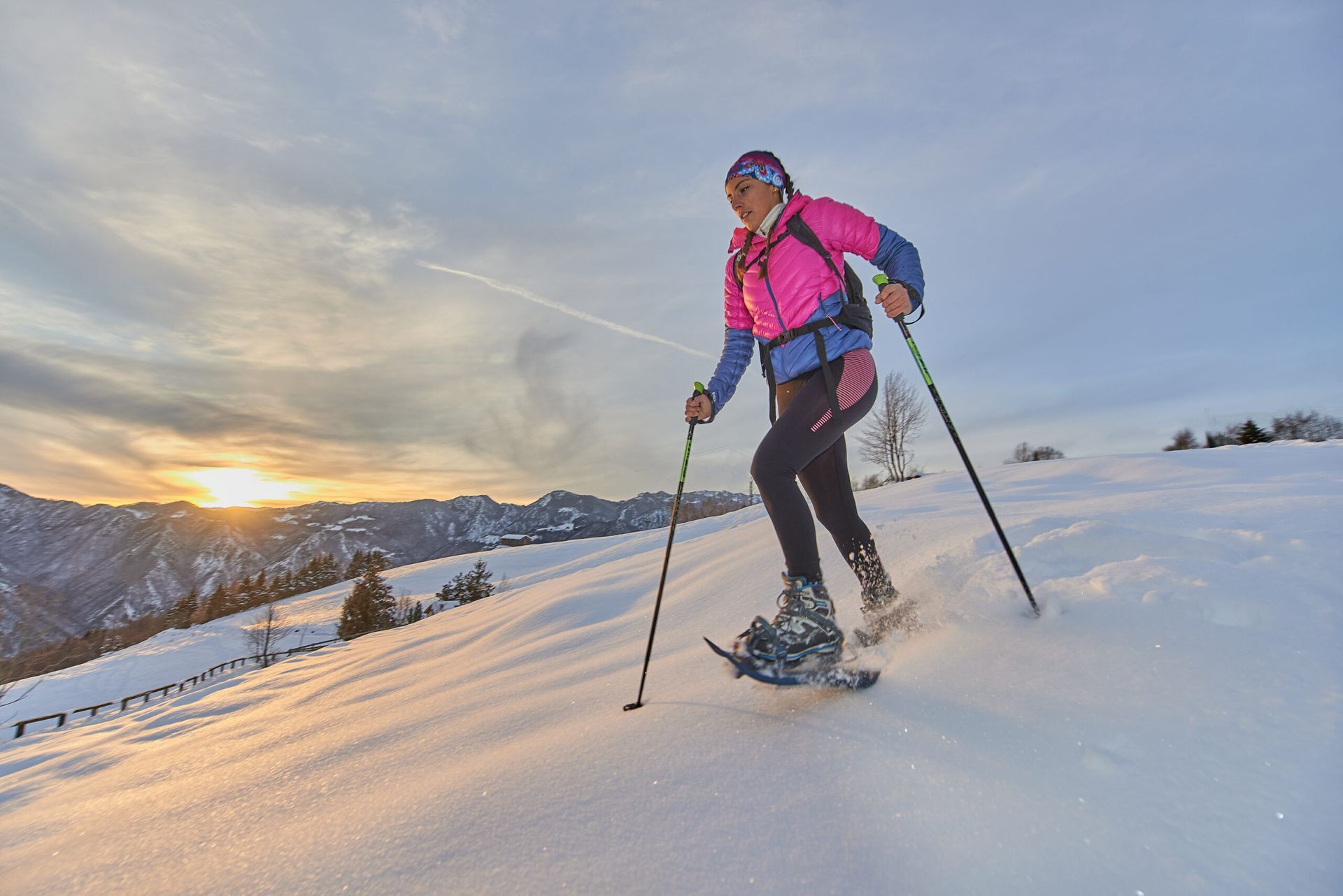 Landscape at sunset in the mountains with girl running downhill