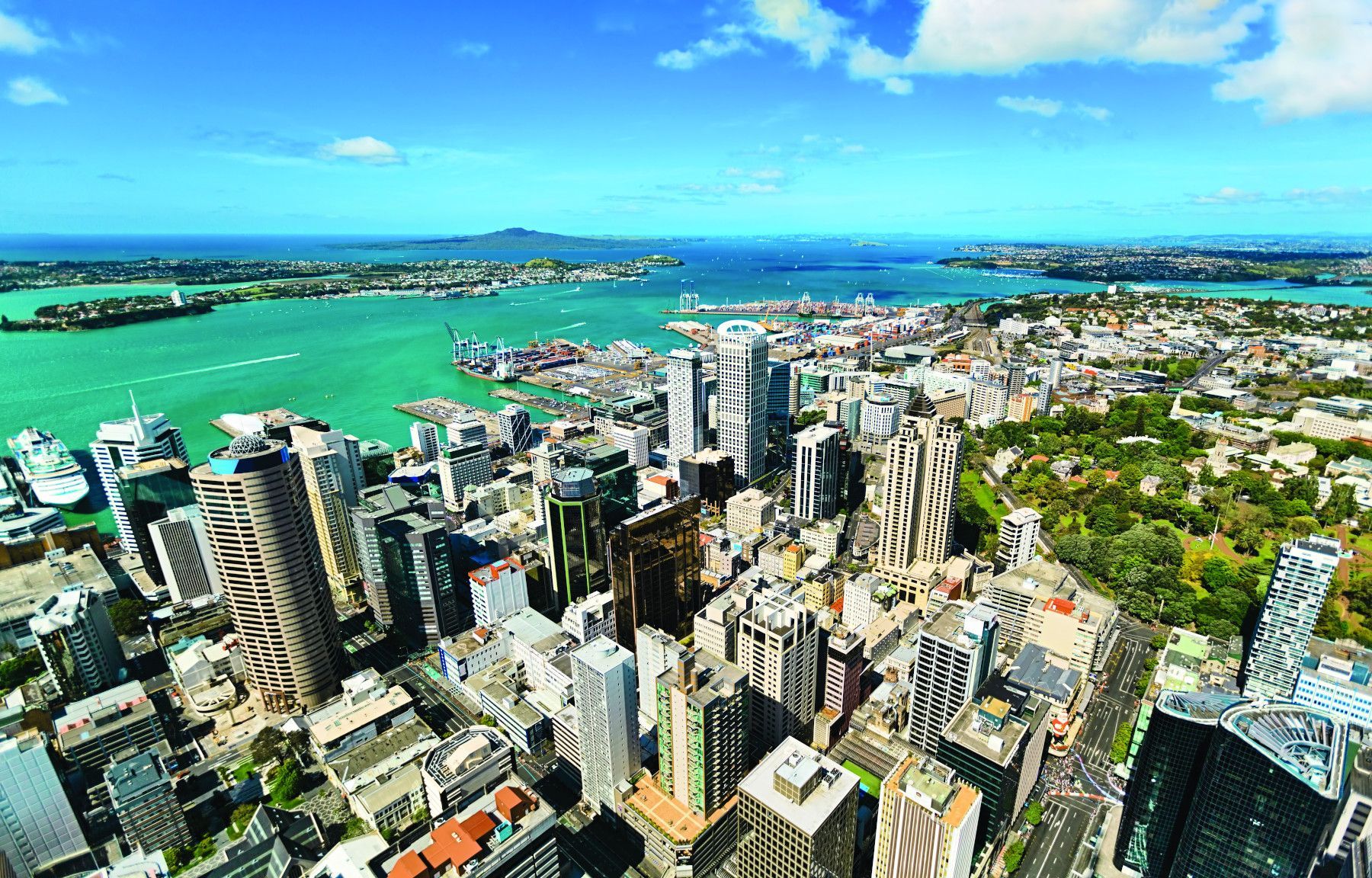 An aerial view of a city with lots of tall buildings and trees.