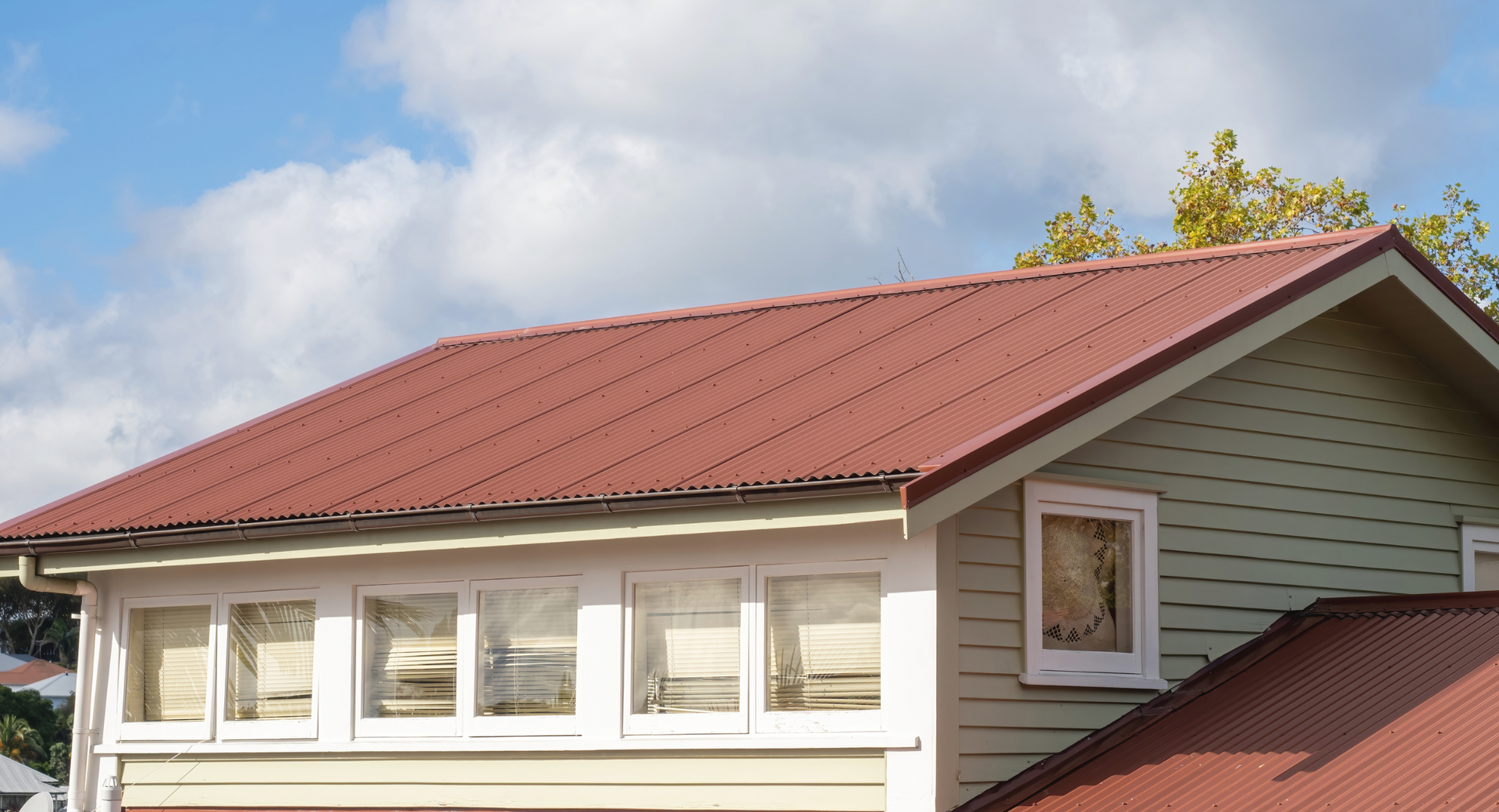 A house with a red roof and white siding