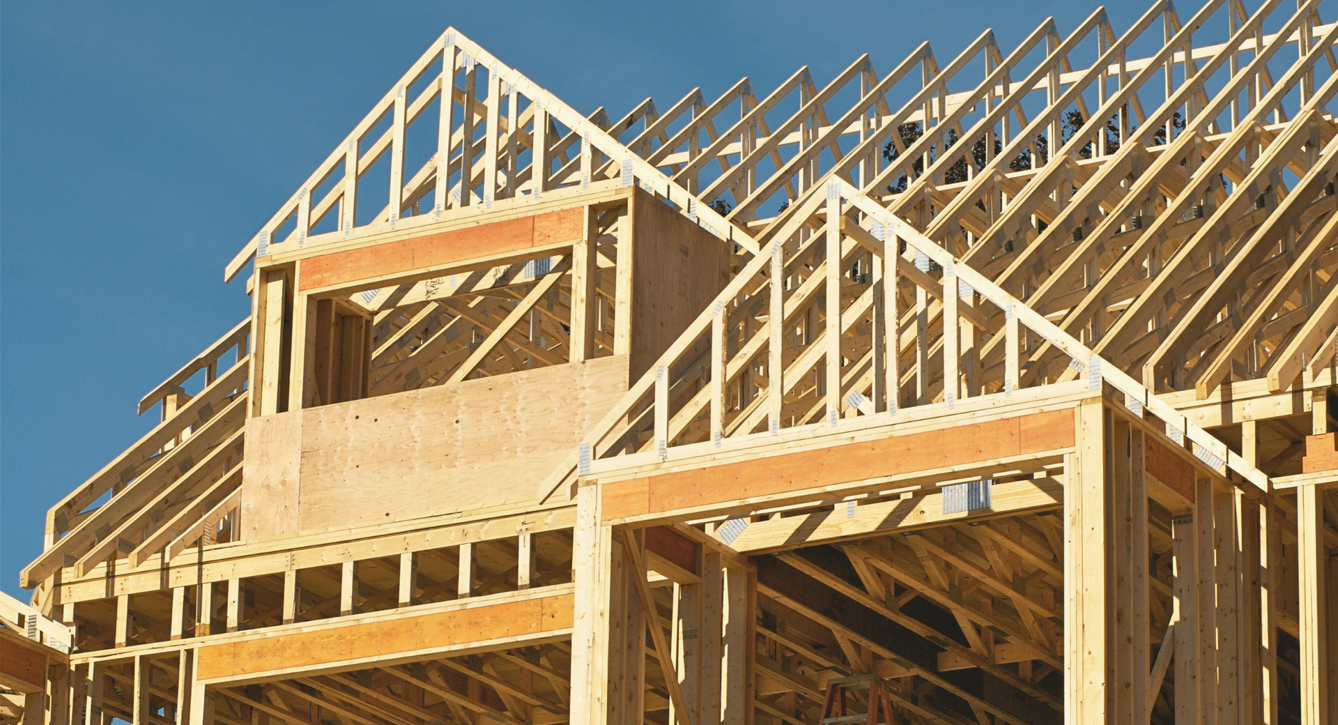 A house is being built with a blue sky in the background.
