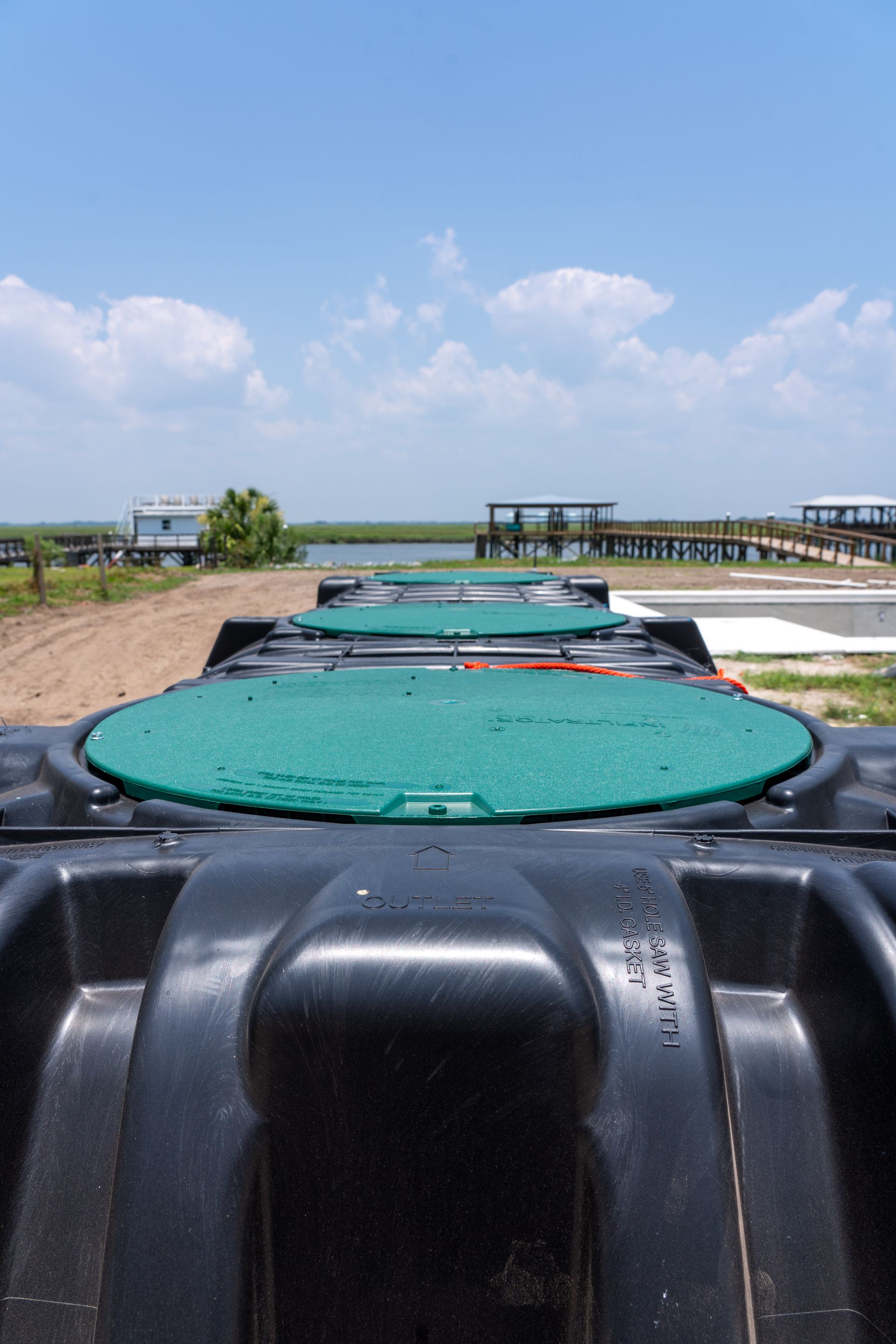 a black container with a green lid that says drain sewer water