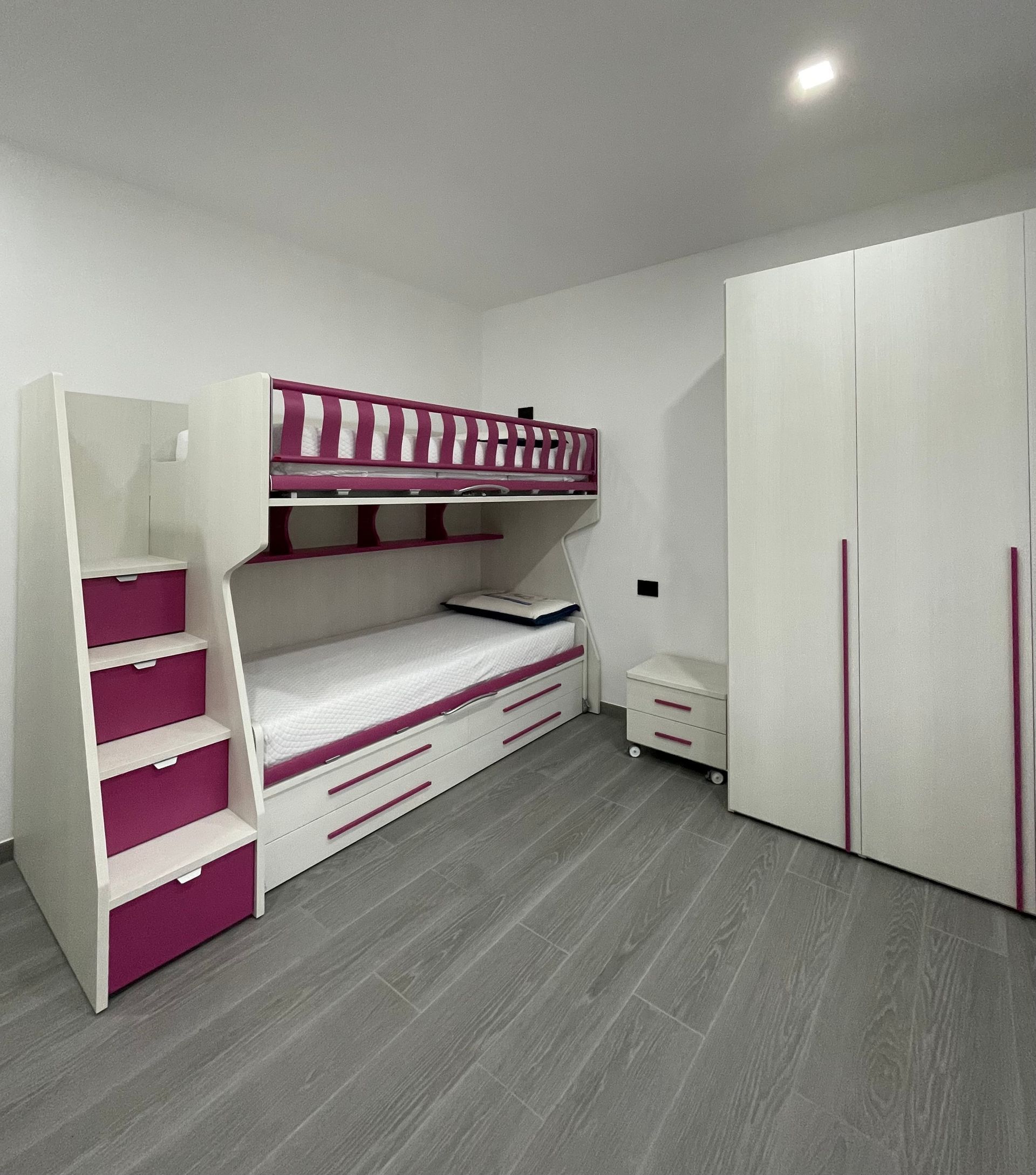 Una camera con letto a castello e scale.