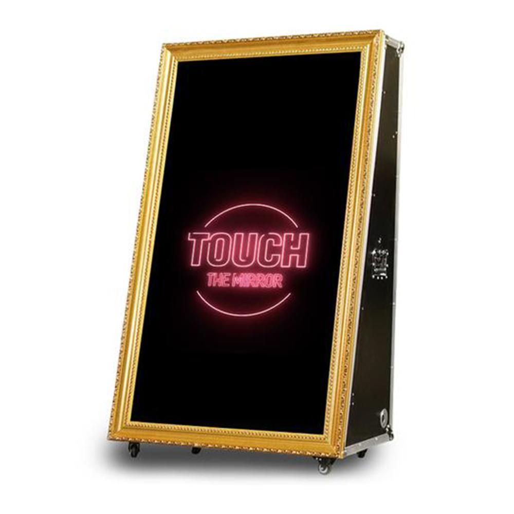 A large mirror with the words touch the mirror on it