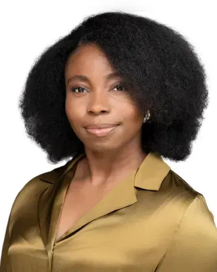 Portrait of a woman with natural black hair wearing a gold blouse against a white background