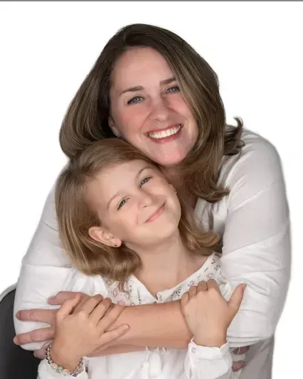 Smiling woman hugging a smiling child against a white background