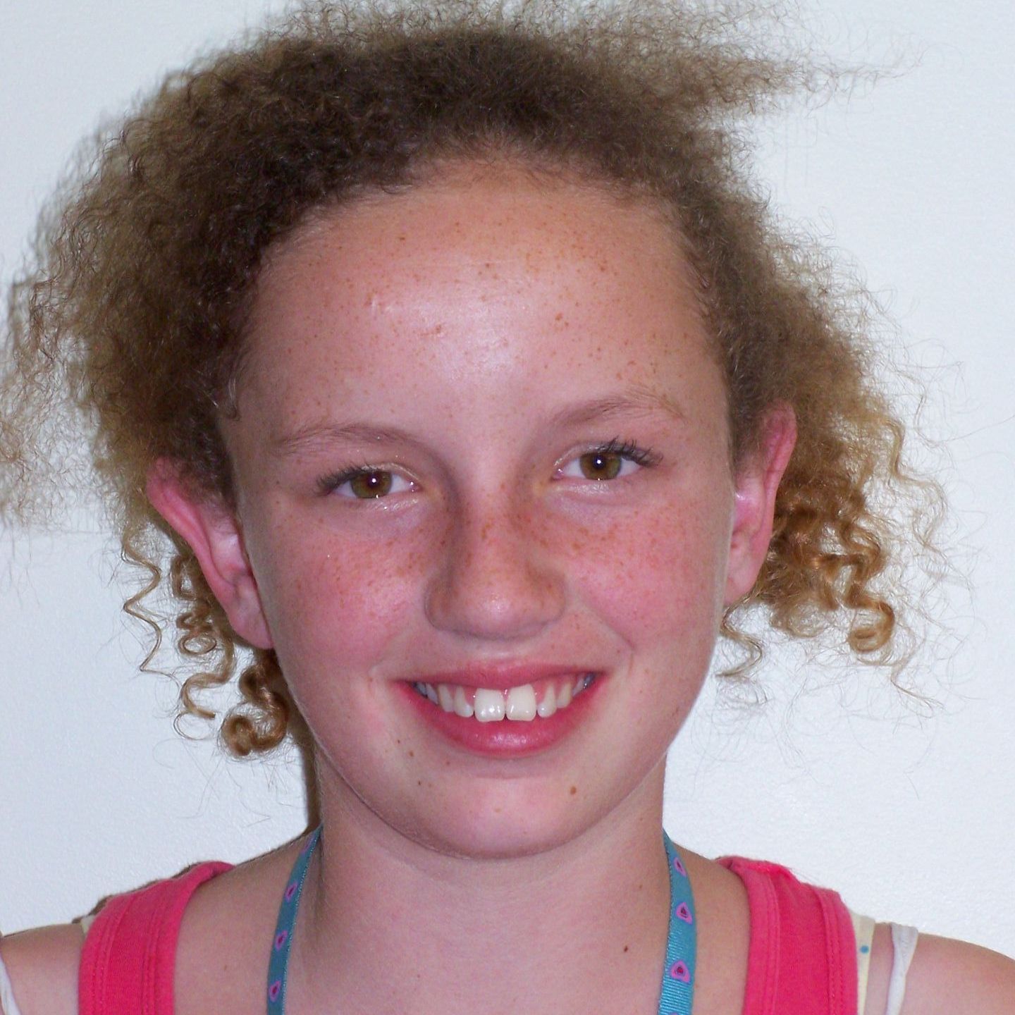 A woman with a black shirt on smiles for the camera