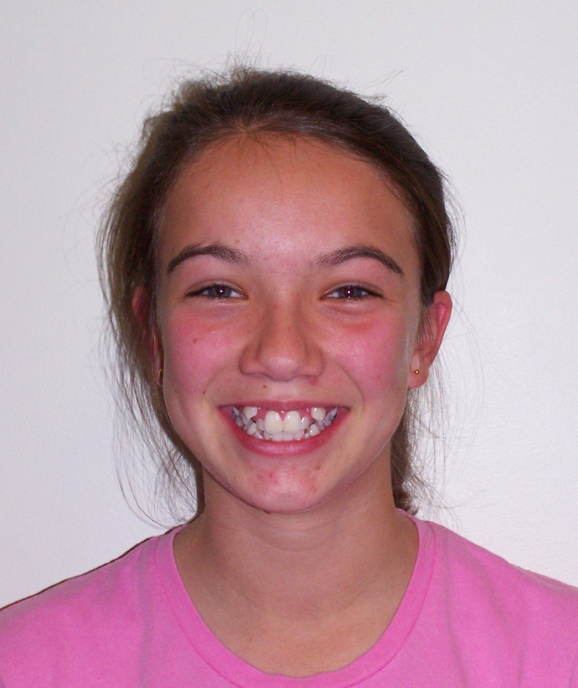 A woman with a black shirt on smiles for the camera
