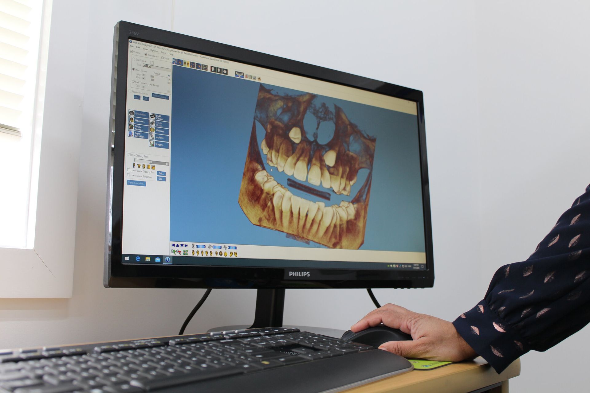 A person is using a computer with a picture of a skull on the screen.