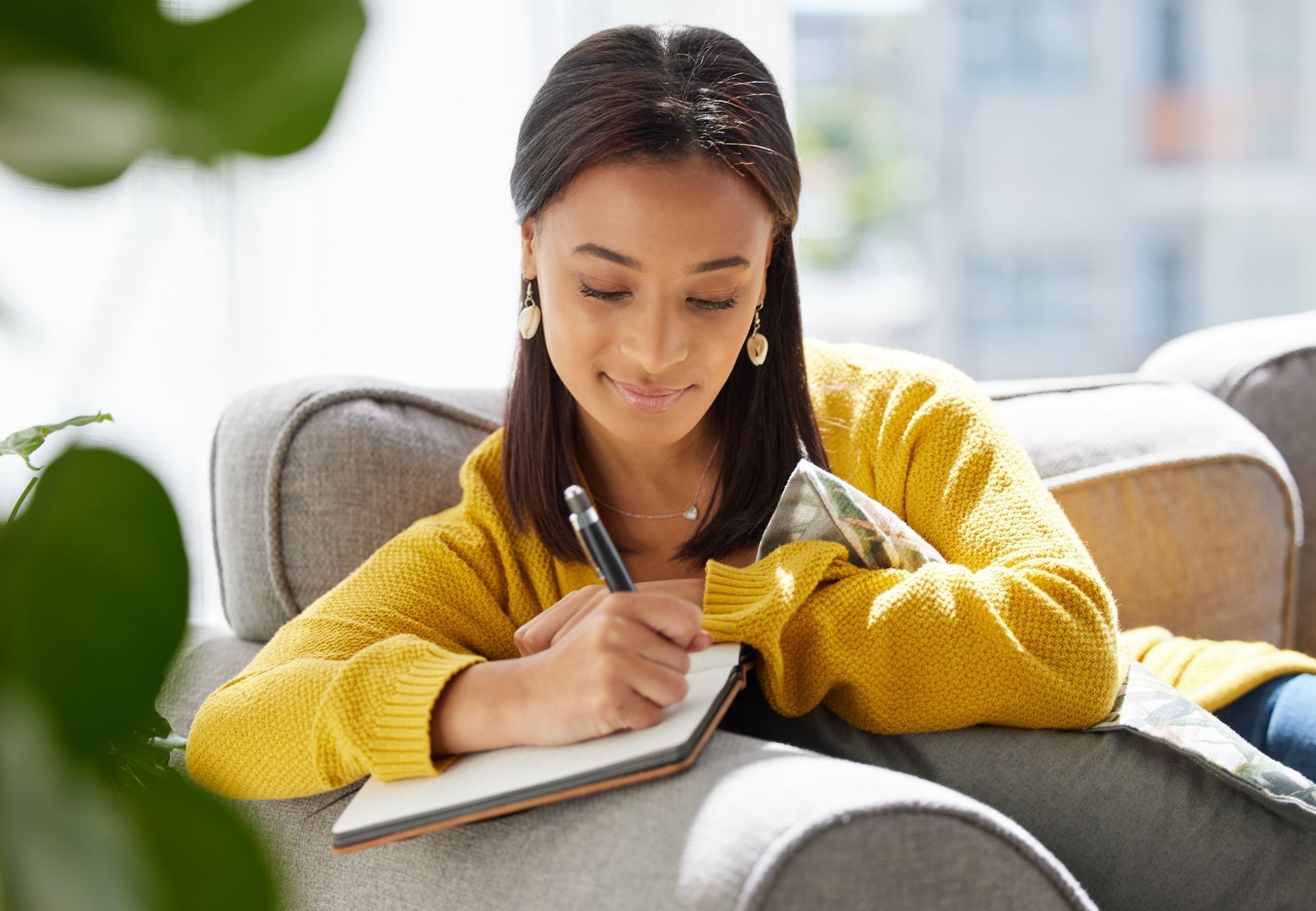 A book titled planning ahead is sitting on a table next to a vase of flowers.