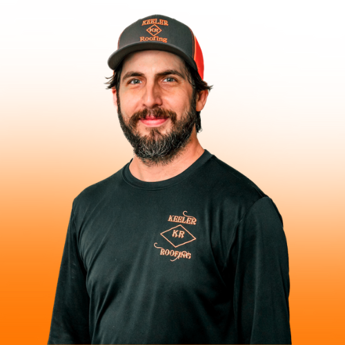 A man with a beard wearing a hat and a green shirt