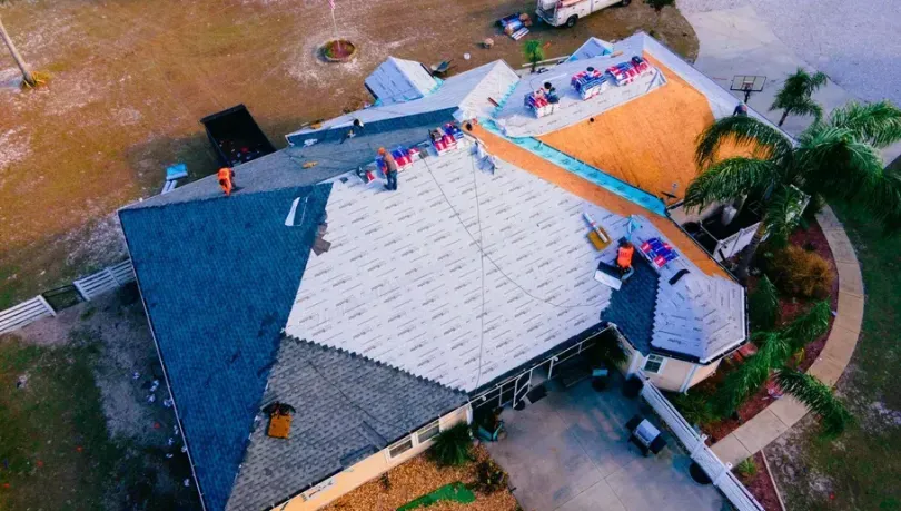 Professional roofing company installing a brand new roof in Florida.