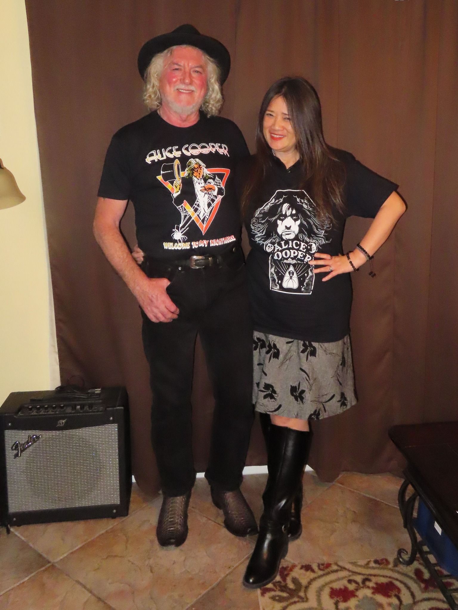 A man and a woman standing next to each other wearing black shirts