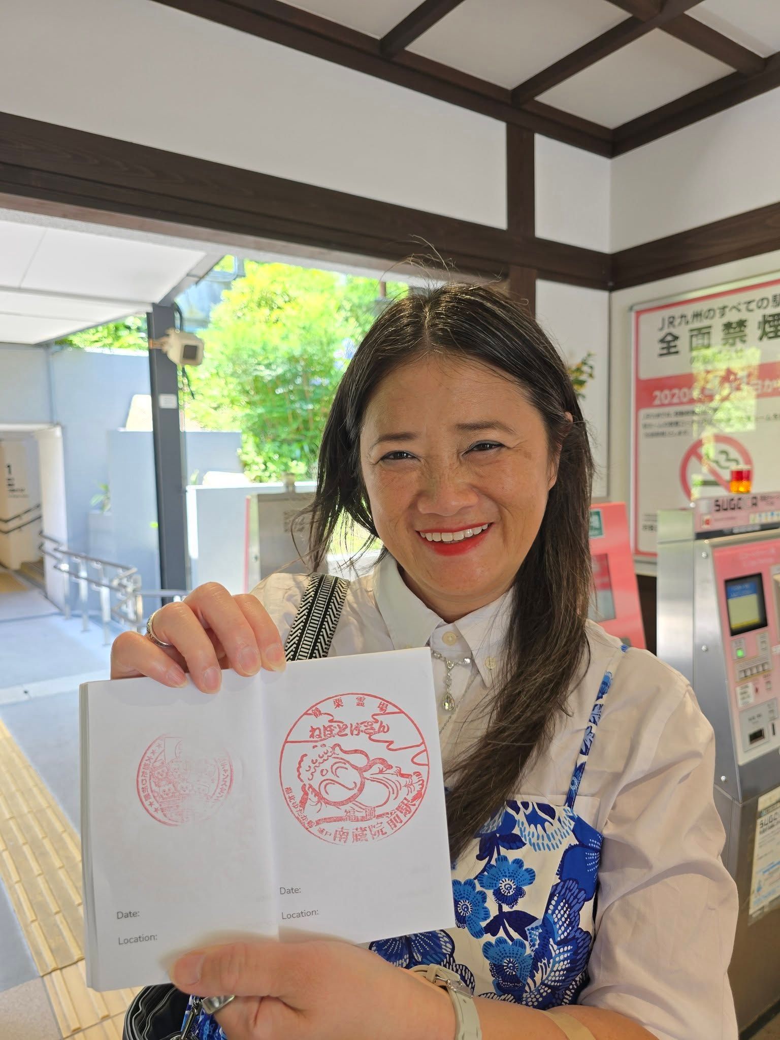 A woman is holding a passport in her hand and smiling.