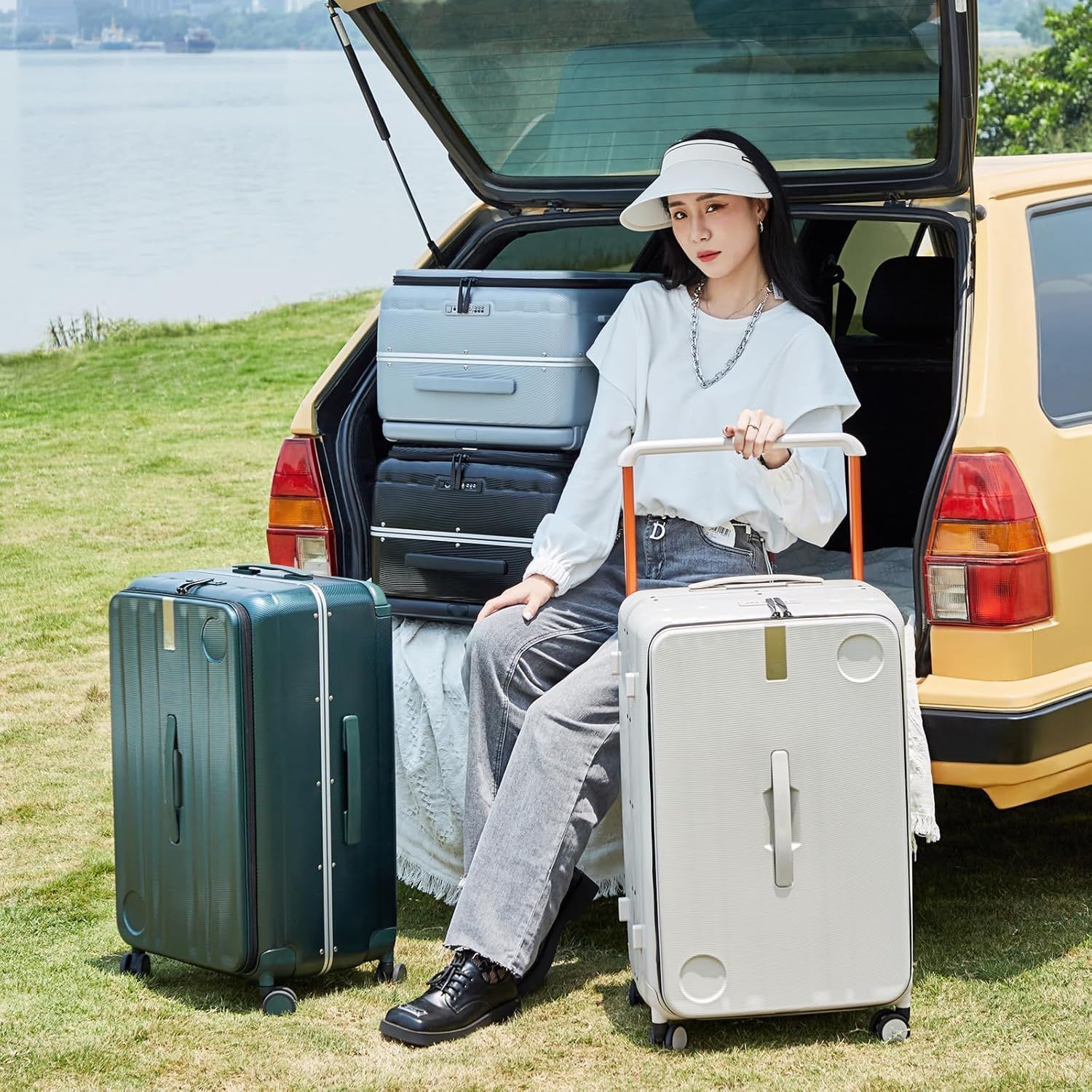 A woman is sitting on a suitcase in the back of a car.