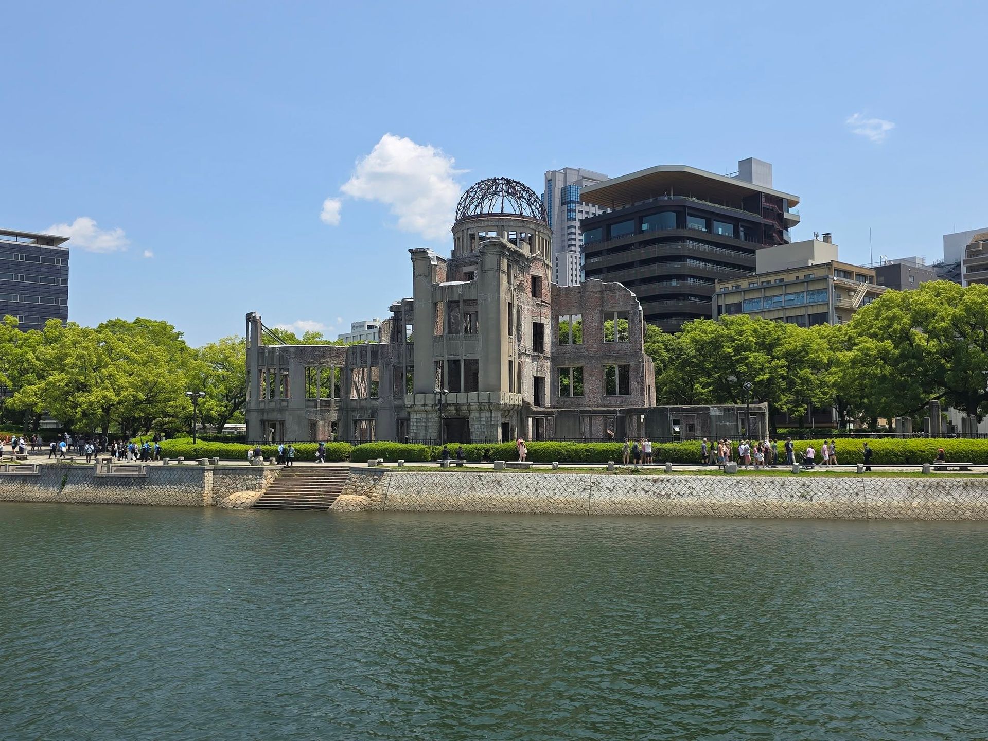 A large building is sitting next to a body of water.