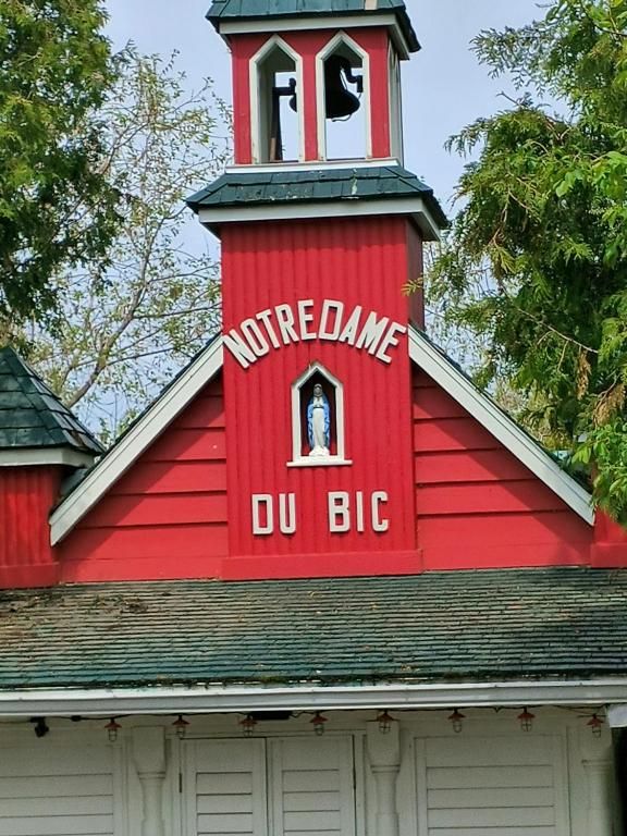 Rood gebouw met witte accenten en een koepel, met het opschrift