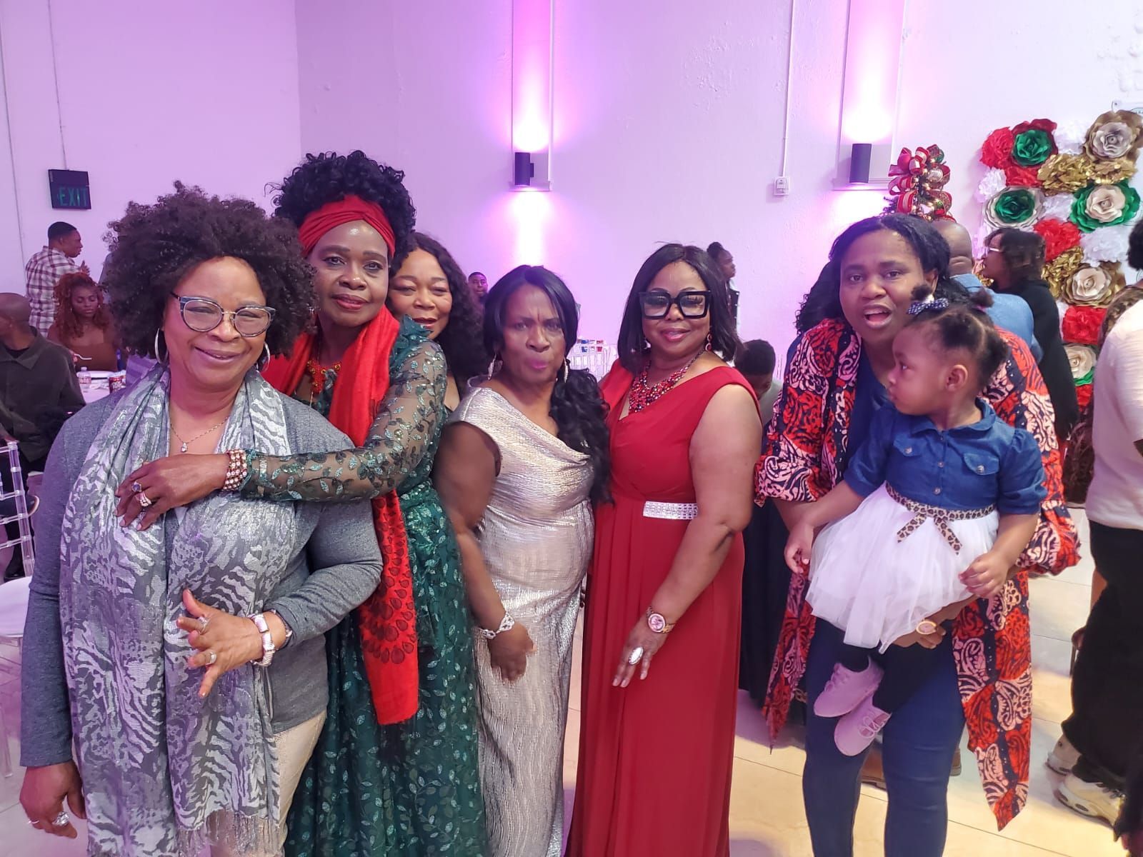 A group of women are posing for a picture at a party.