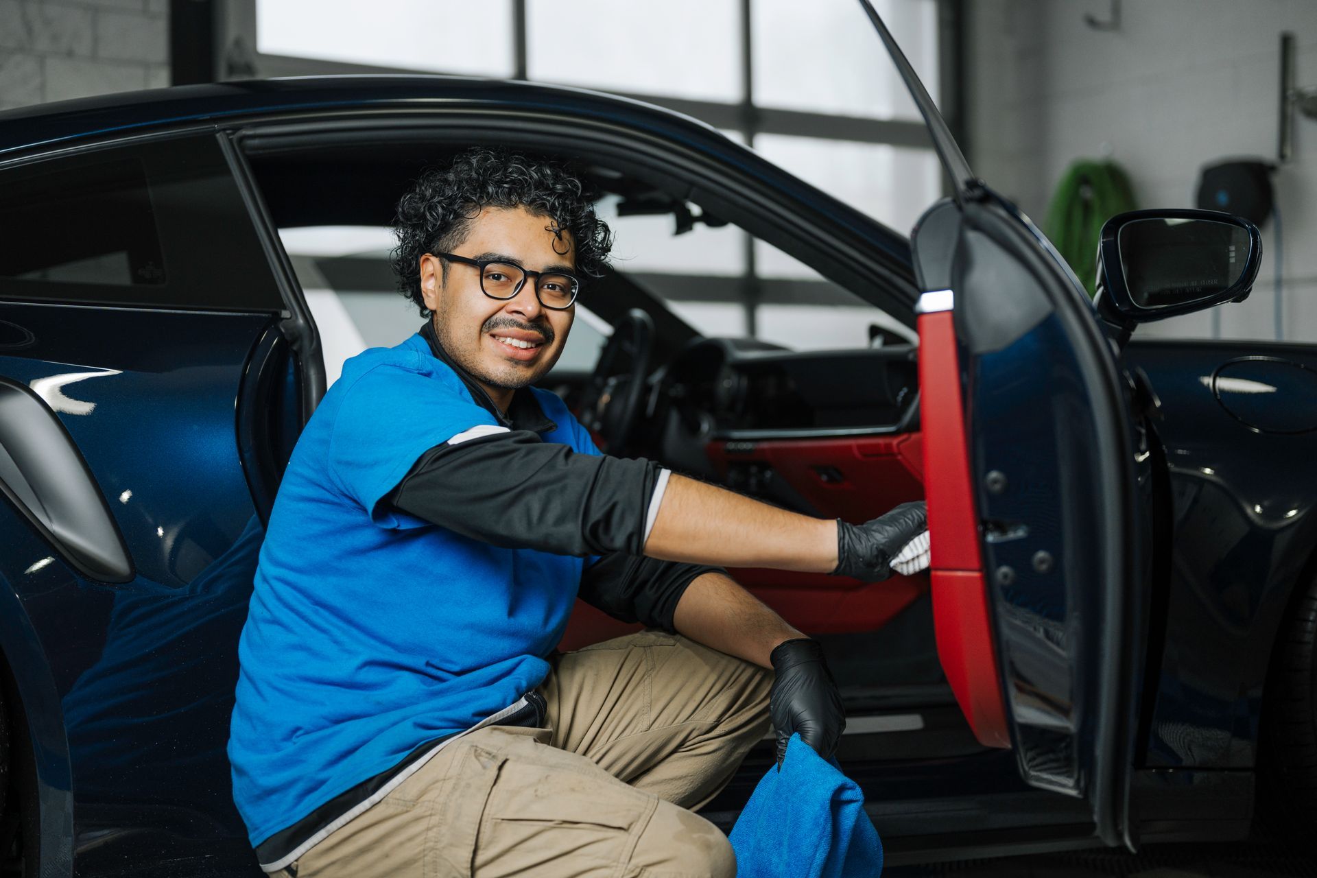 A man is sitting in the driver 's seat of a car.