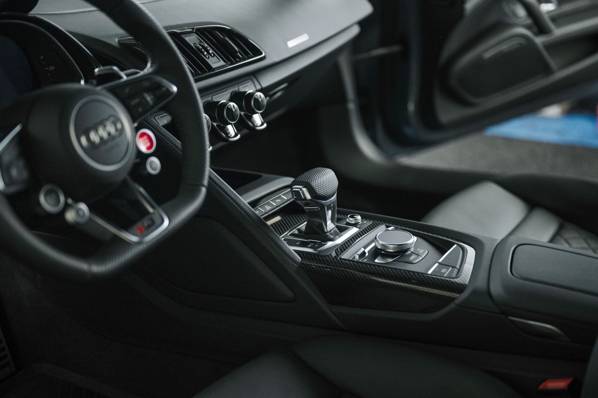 A close up of the interior of a car with the door open.