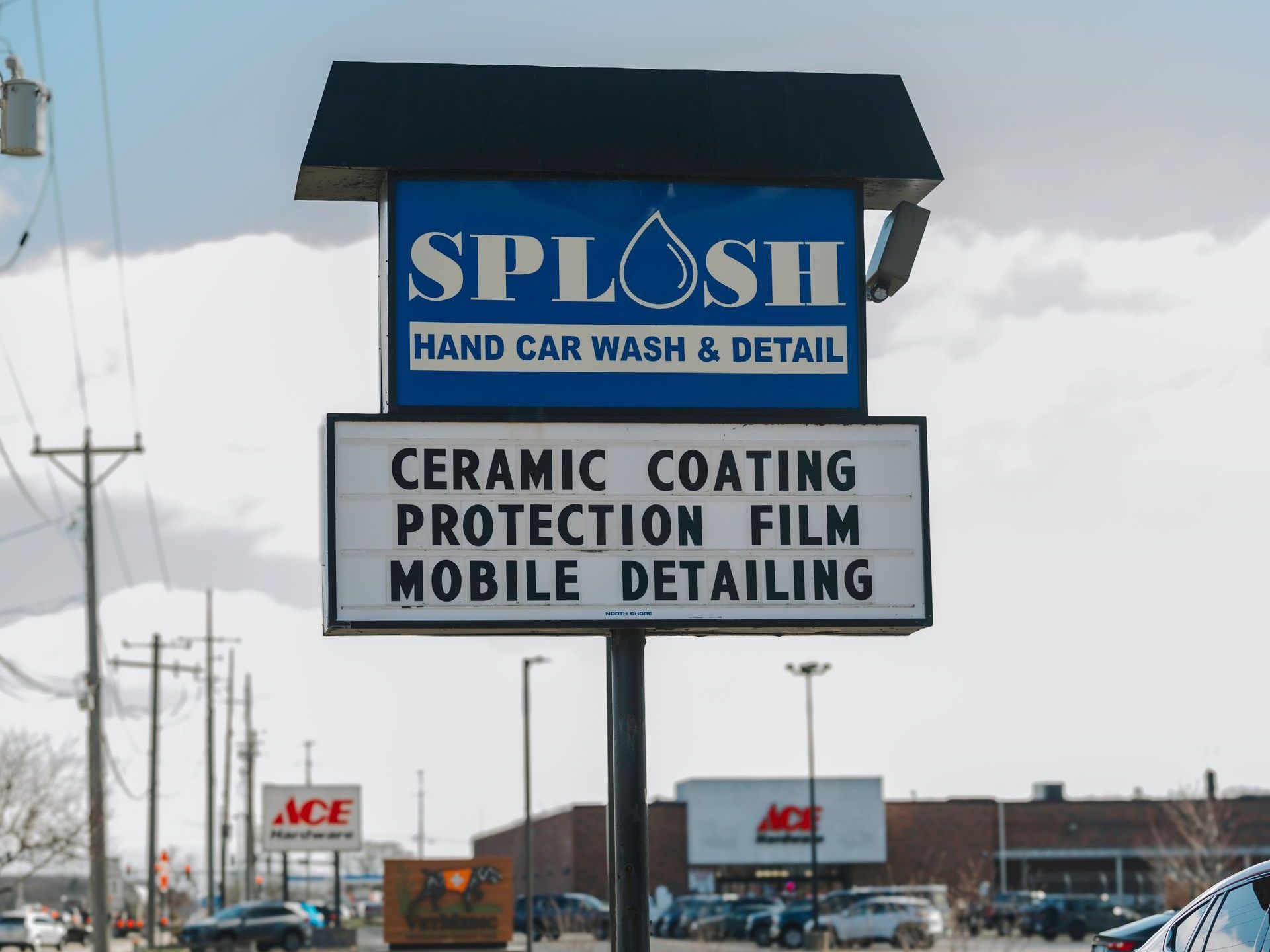 Sign for Splosh Car Wash offering ceramic coating, protection film, and mobile detailing