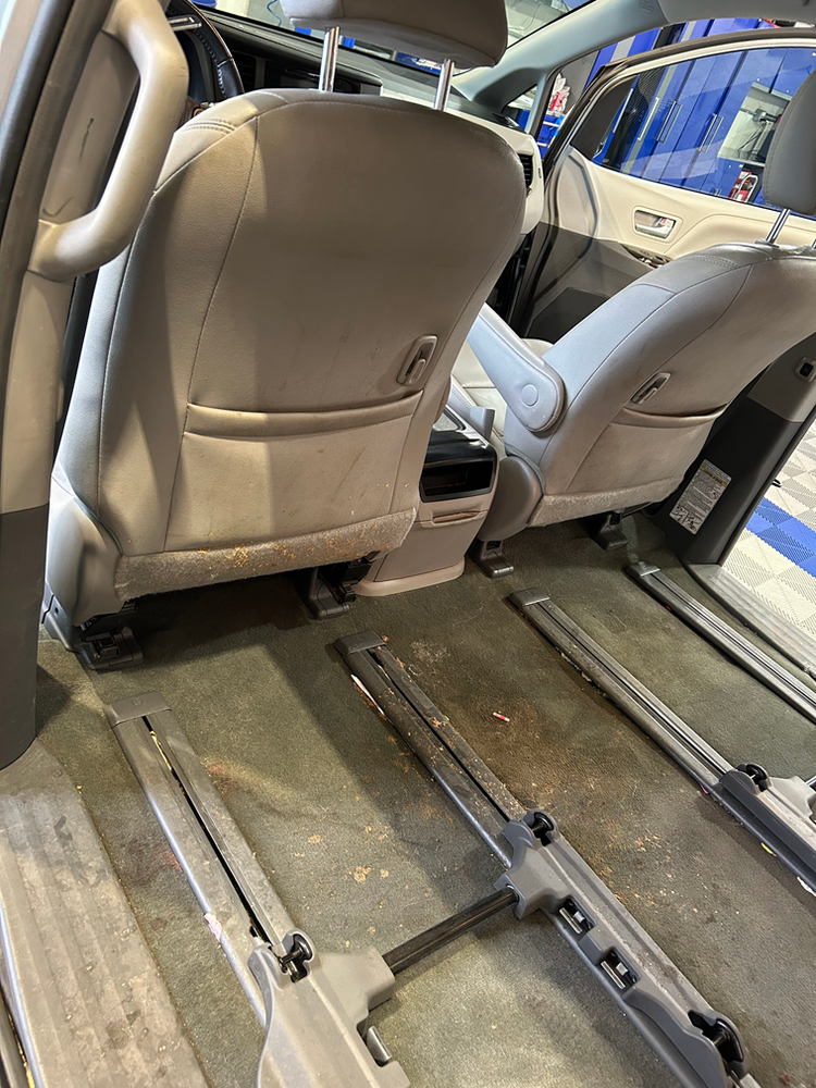The back seats of a car are empty and the trunk is open.