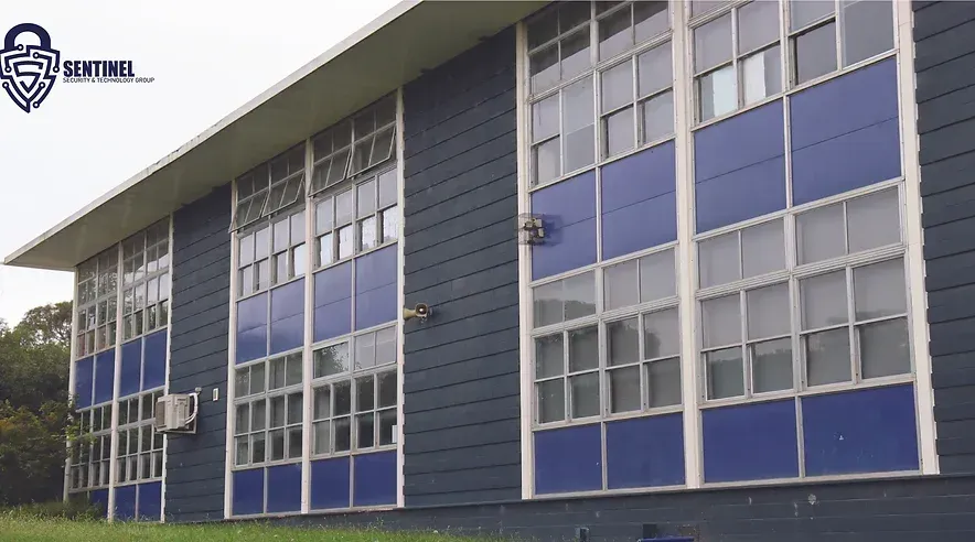 A blue building with a sentinel logo on it