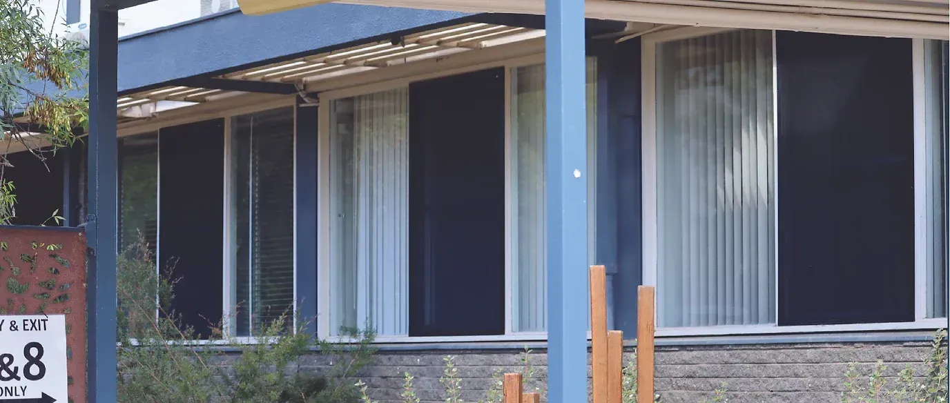 A house with a porch and a sign that says 88 on it.