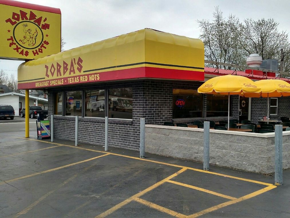 Zorba's Texas Hots restaurant. Exterior view of a building with yellow and red awning.