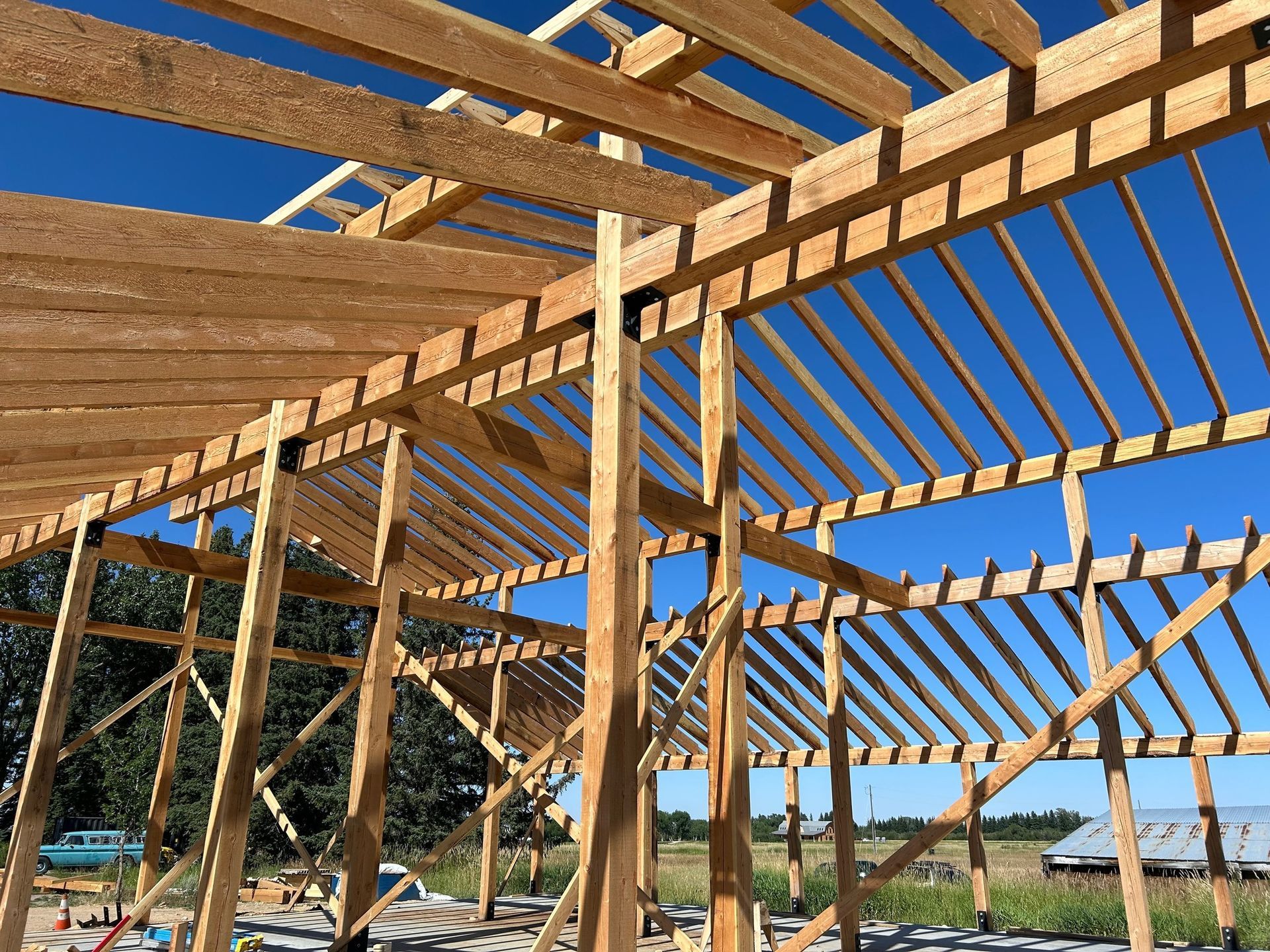 A wooden structure under construction with a blue sky in the background.