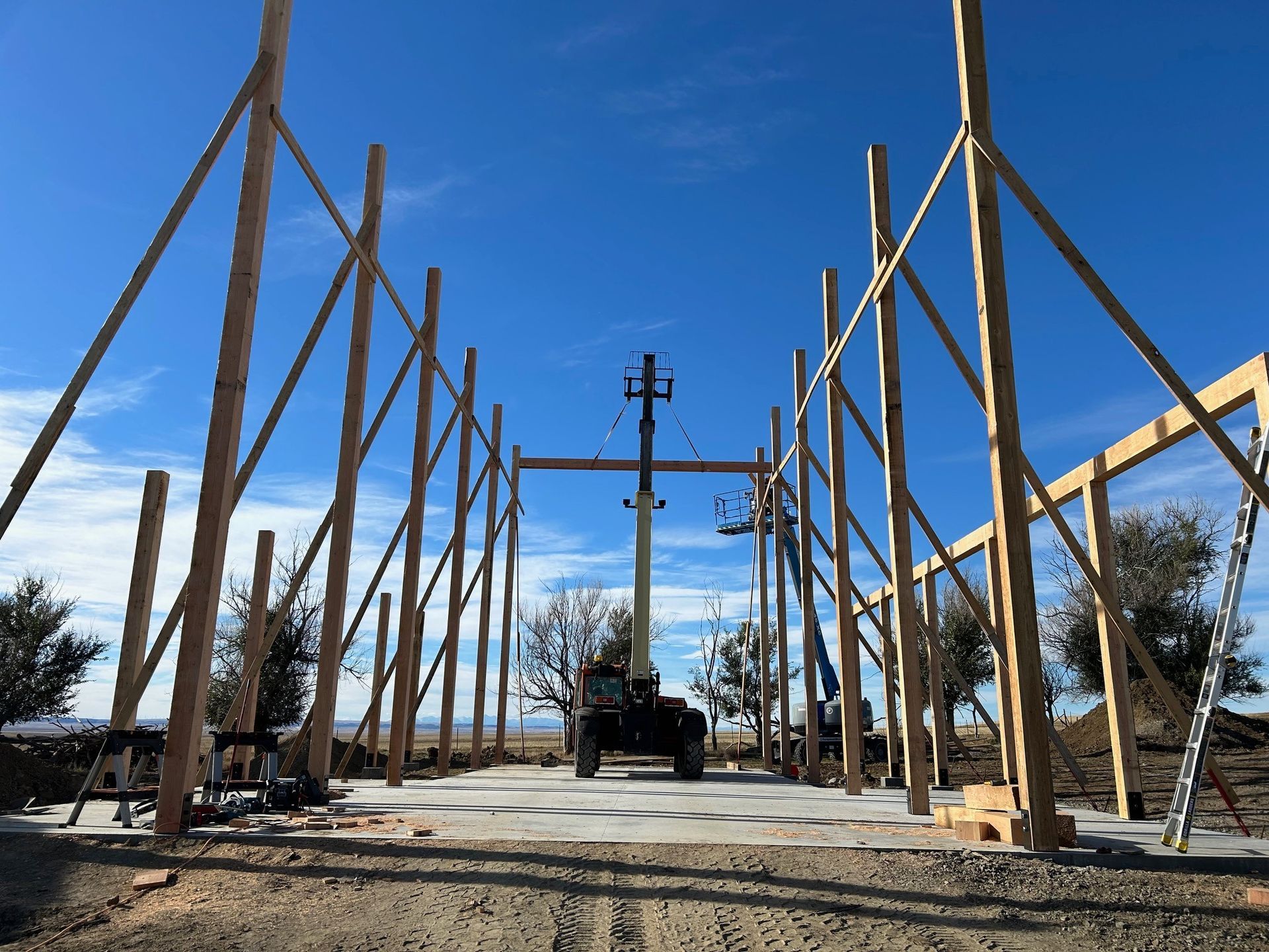 A large wooden structure is being built in the desert