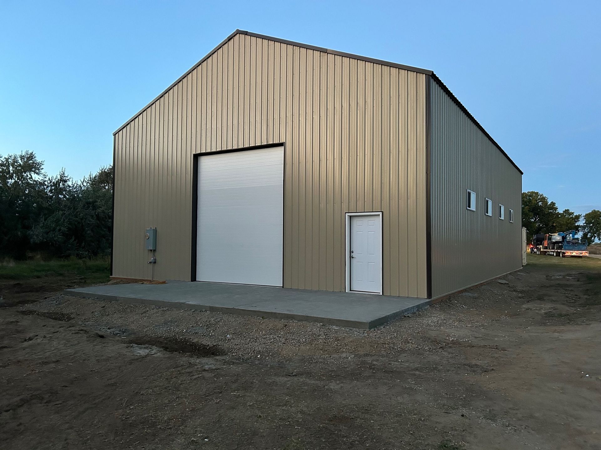 A large metal building with a white garage door