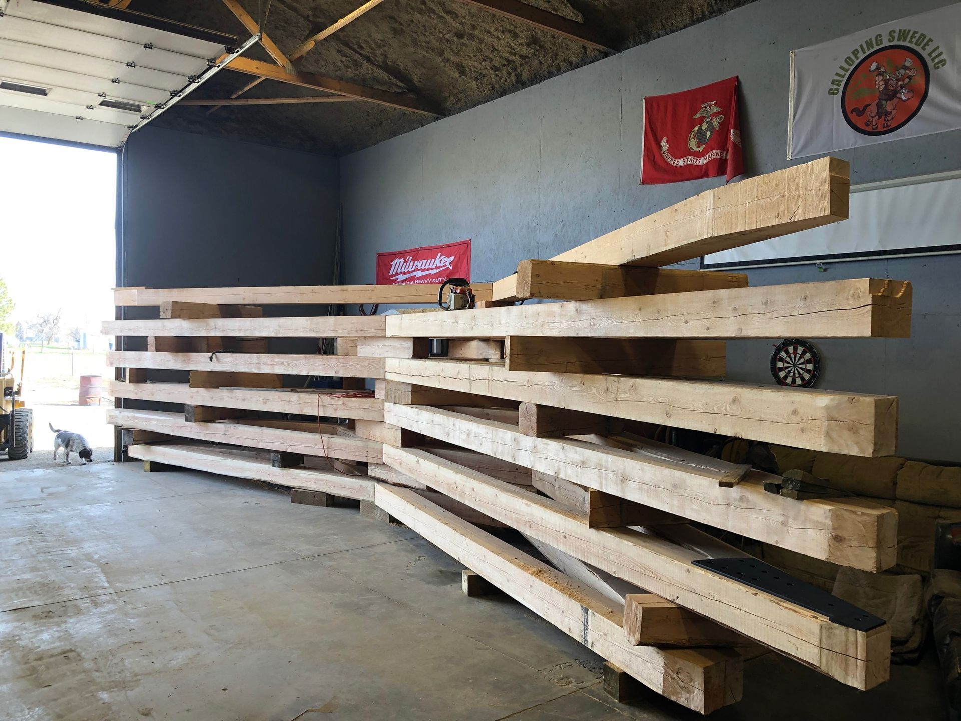 A bunch of wooden beams are stacked on top of each other in a room.