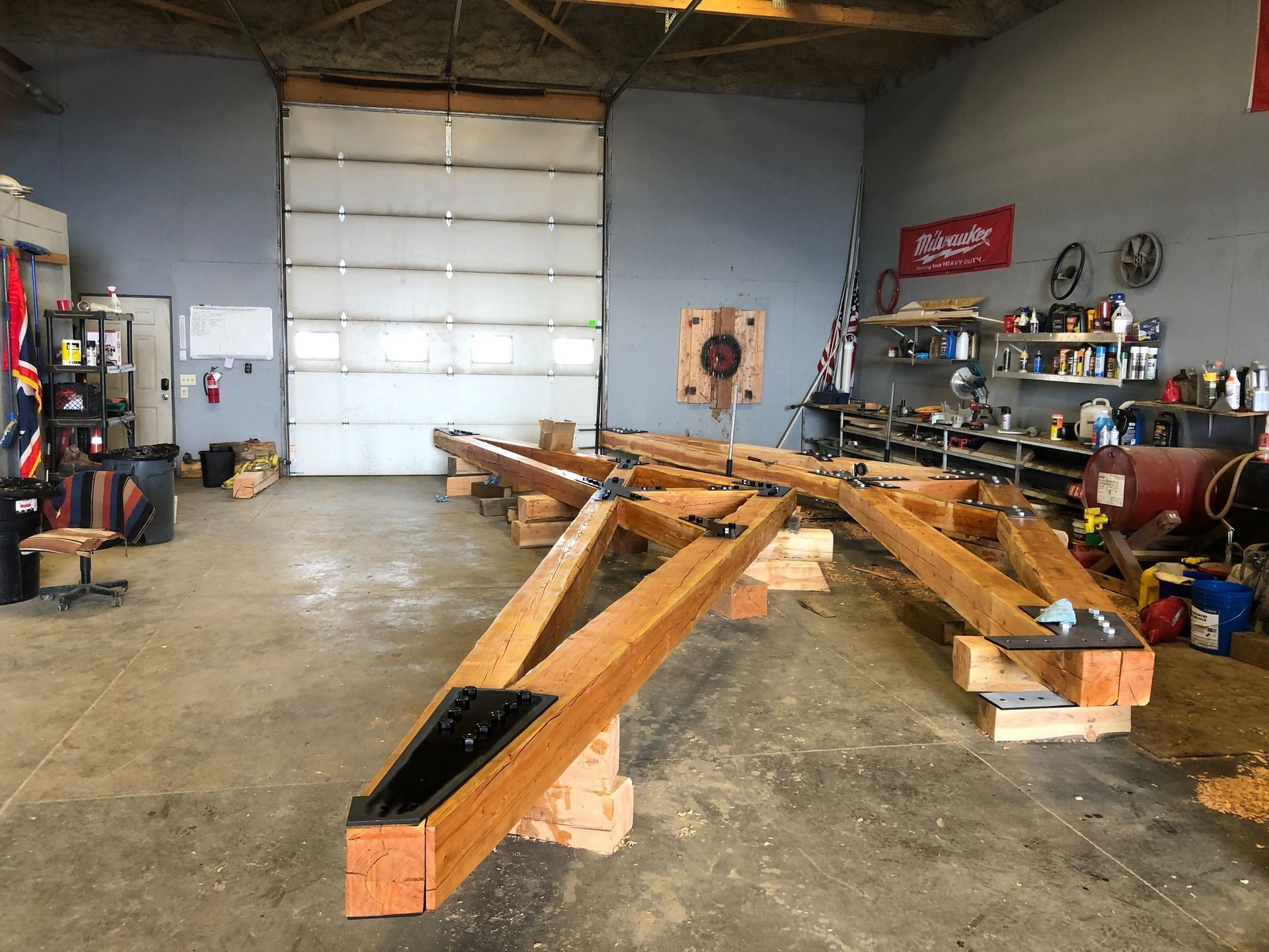 A large wooden structure is being built in a garage.