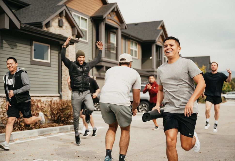 Group of men running outdoors — The District at Parkcenter