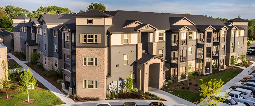 Apartment building with dark gray roofs — Parkcenter Apartments