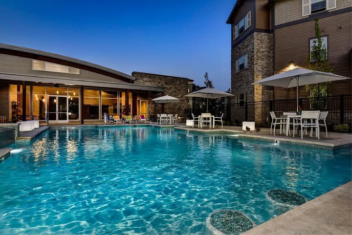 Swimming pool with bar stools — The District at Parkcenter