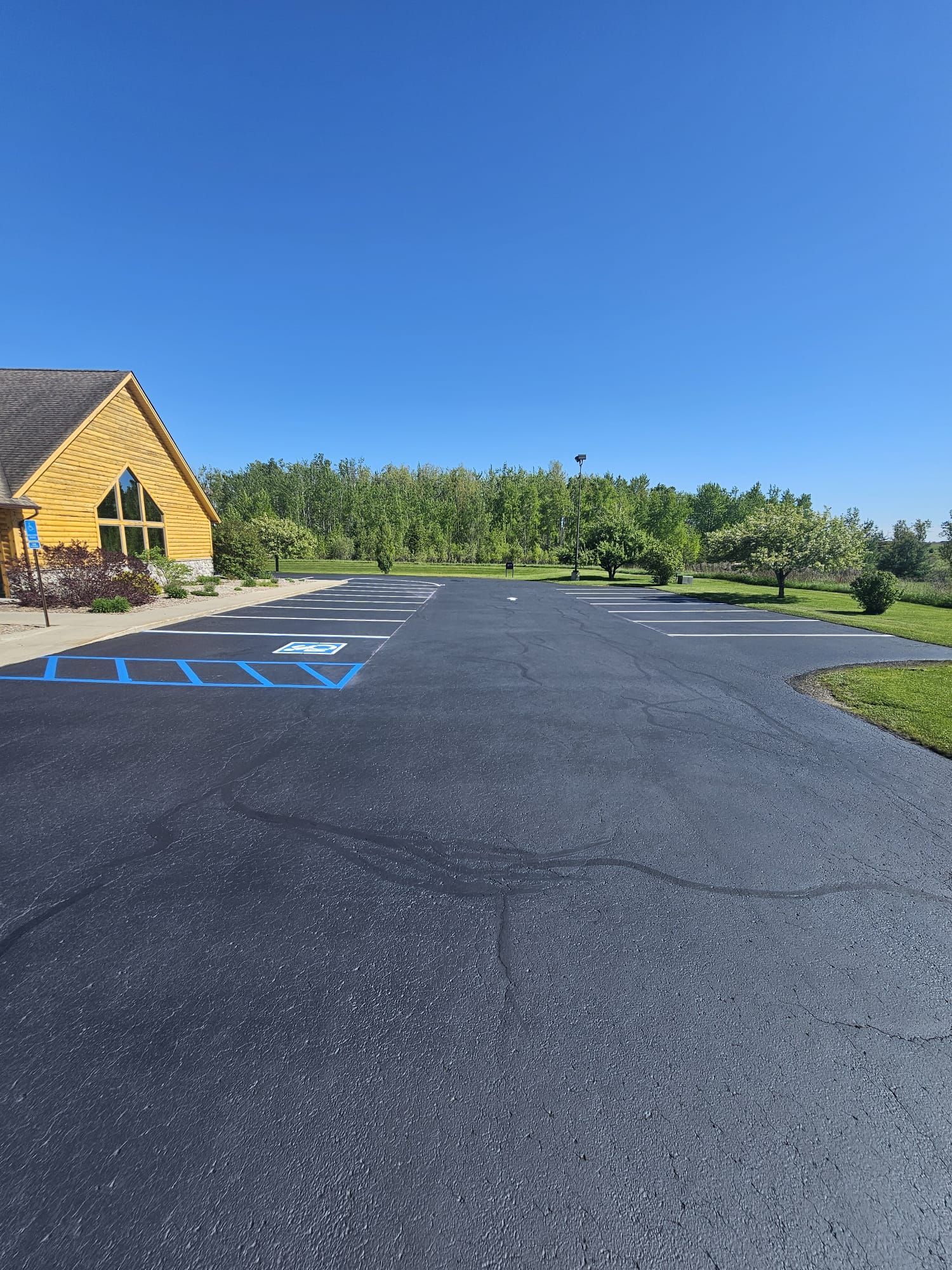 orsa credit union in hillman line striped with parking and handicap parking symbols and sealcoated