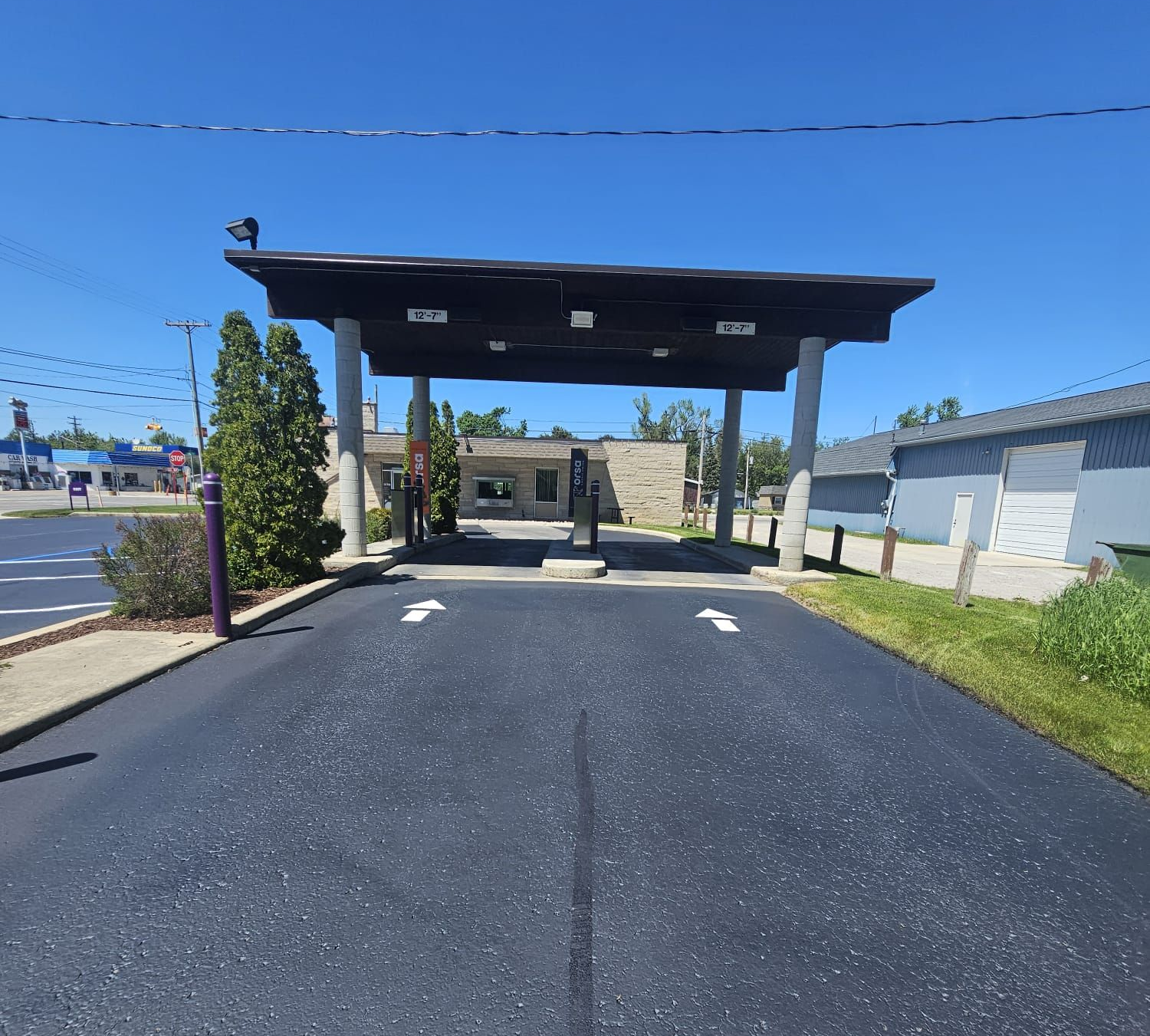 atlanta michigan orsa credit union with fresh sealcoat and new traffic symbols painted on the asphalt by alpena asphalt armor llc