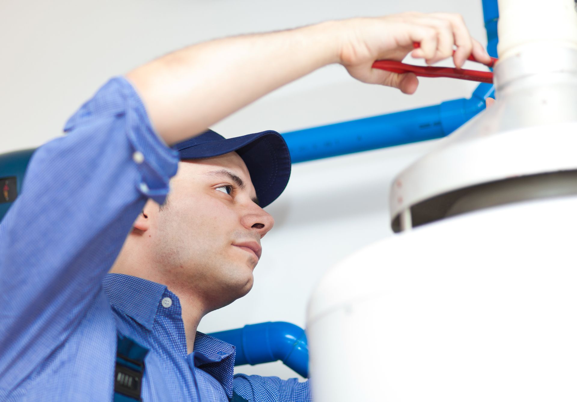 Technician from Dan Wood Company doing a hot water heater replacement in Kalamazoo, MI Technician from Dan Wood Company doing a hot water heater replacement in Kalamazoo, MI