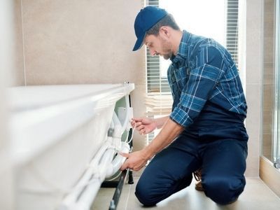 Plumber Fixing Tub — Portage, MI — Dan Wood Company